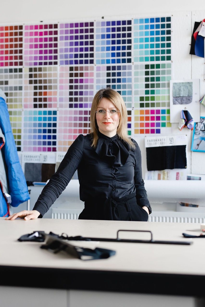 Jenna Gardner in front of a vibrant colour sample wall at Blackburn College. Image Christina Davies, Fish2Photo.