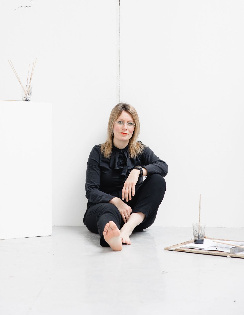 Jenna Gardner seated on the floor of a studio space at Blackburn College. Image credit Christina Davies, Fish2Photo.