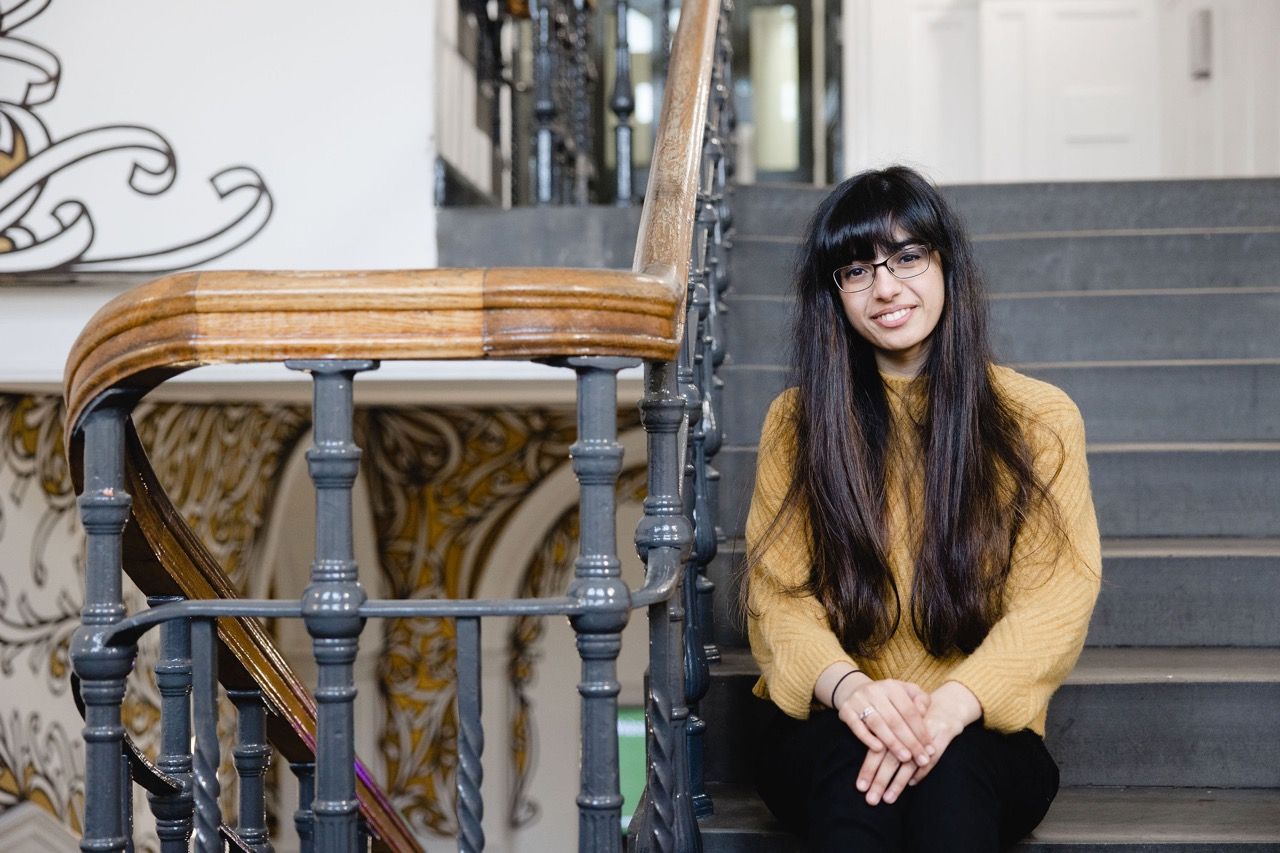 Maariyah Patel seated on the stairs at The Storey, Lancaster. c. Christina Davies, Fish 2 Photo.