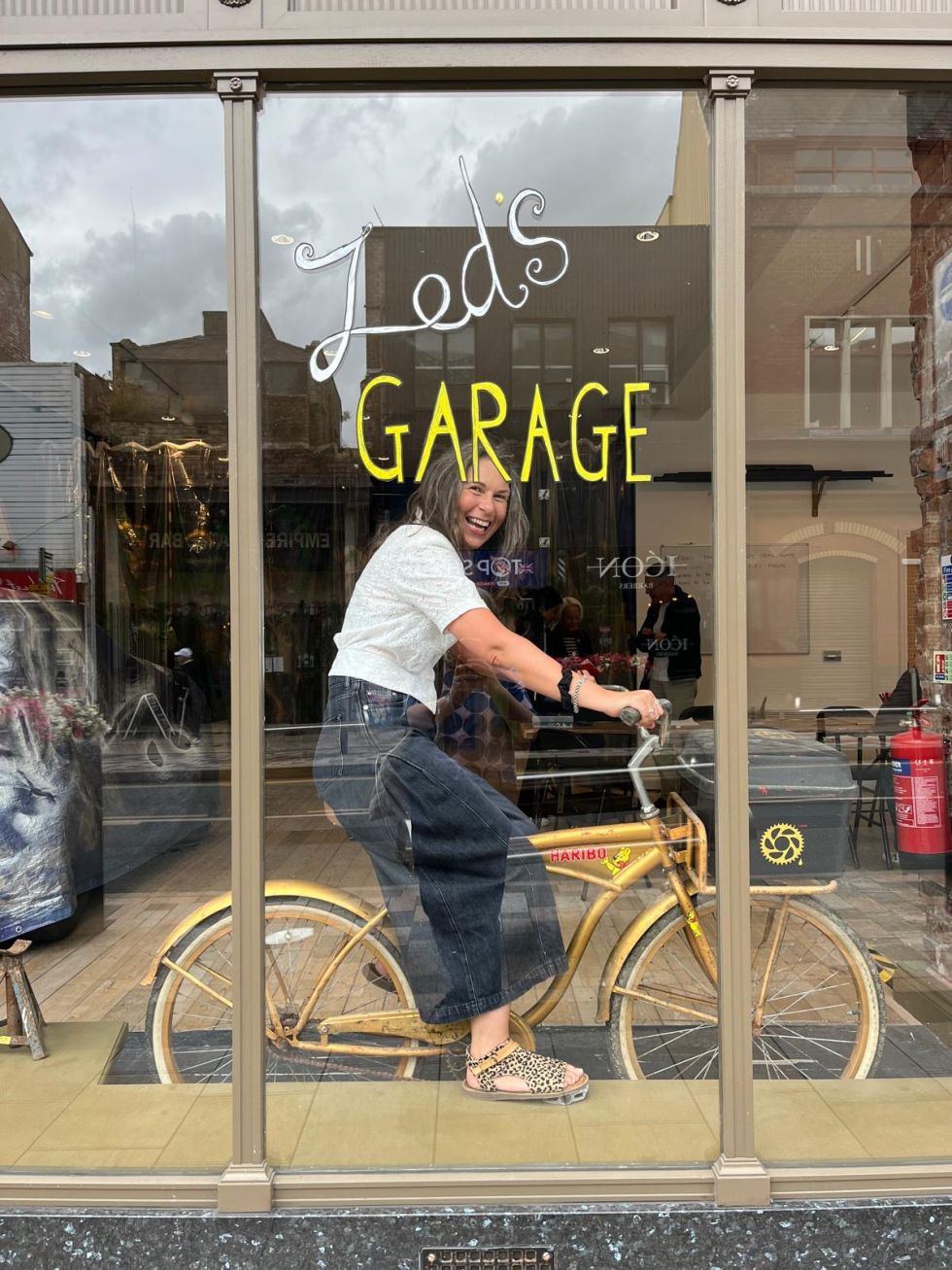 Karen Green on a bicycle in Zed's Garage