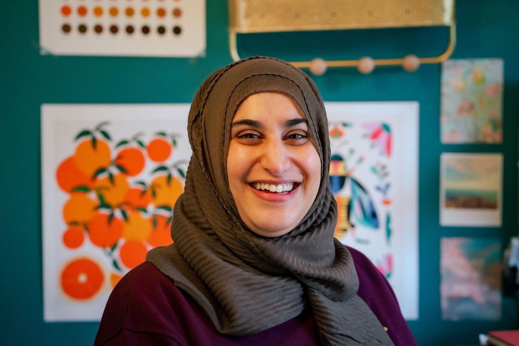 Reyhana Ismail smiling for camera in her studio, image by Rachel Ovenden.