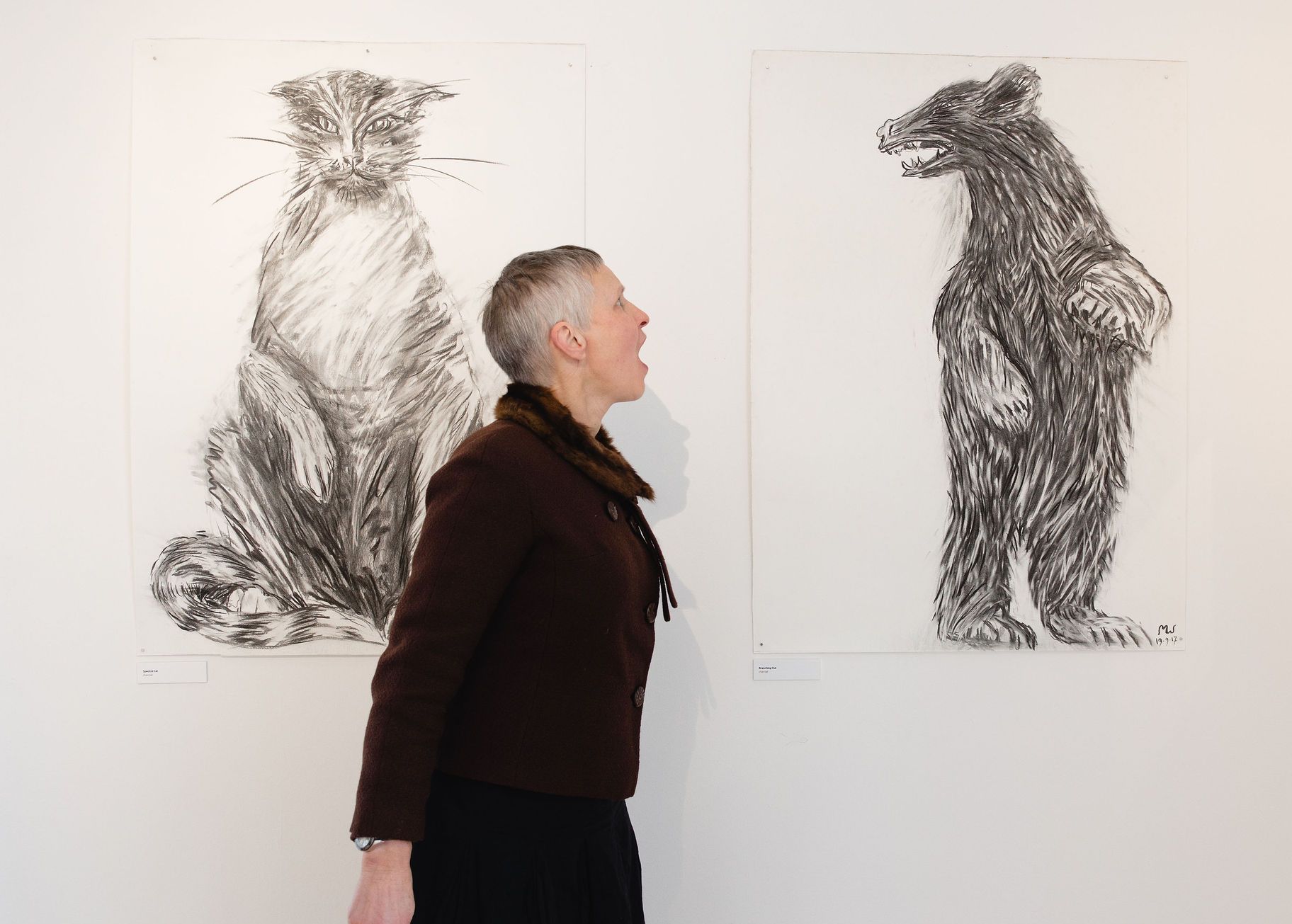 Marjan roaring at her bear illustration on display at The Whitaker. Imager by Christina Davies, Fish2Photo.