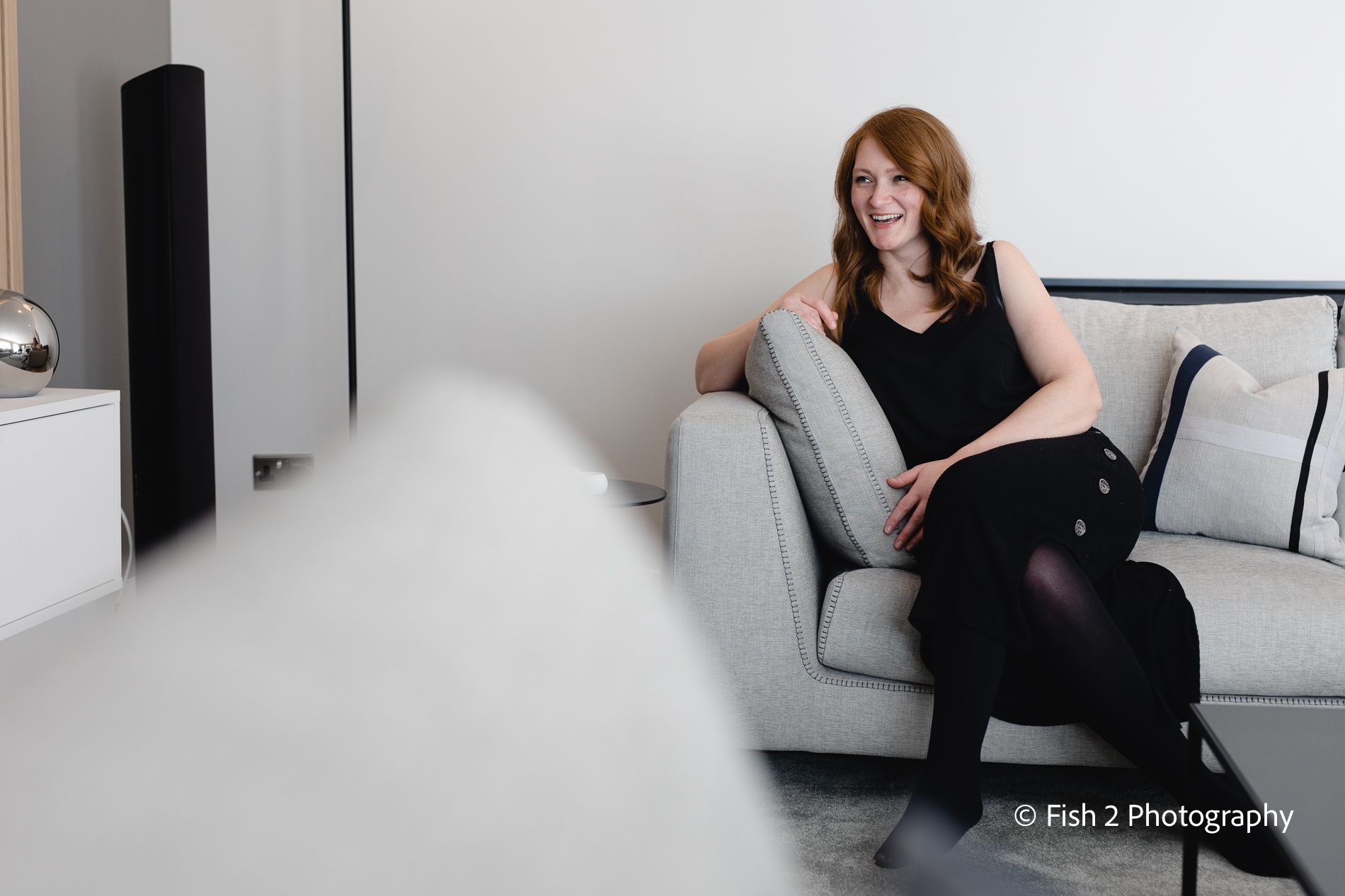 Alisa Bowen of Inside Studio seated on a sofa, image by Christina Davies, Fish 2 Photography.