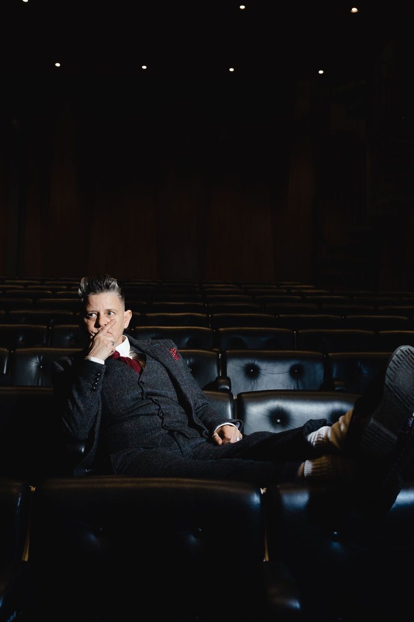 Joelle Taylor seated in a theatre row at The South Bank Centre. Image by Christina Davies, Fish2Photo.